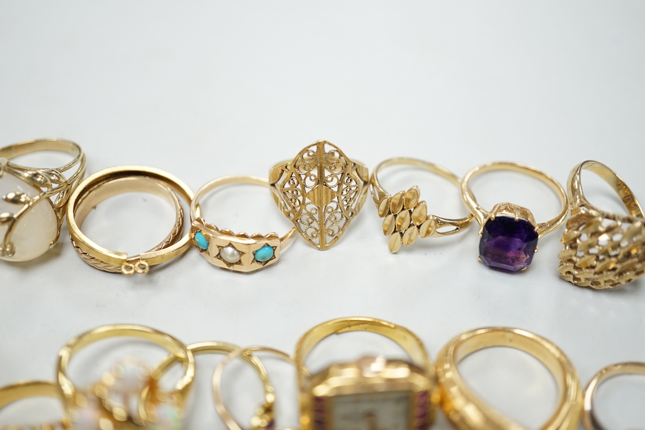 Three 18ct and gem set rings including star sapphire, turquoise and pearl and ruby and diamond three stone, five 9ct gold rings and a 9ct gold pendant mount and nine other rings including ring watch and Middle Eastern tu